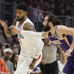 Los Angeles Clippers forward Paul George, left, and Phoenix Suns guard Ricky Rubio chase a loose ball during the first half of an NBA basketball game in Los Angeles, Tuesday, Dec. 17, 2019. (AP Photo/Chris Carlson)