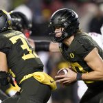 Oregon quarterback Justin Herbert (10) scrabbles out of the pocket against Utah during the first half of the Pac-12 Conference championship NCAA college football game in Santa Clara, Calif., Friday, Dec. 6, 2018. (AP Photo/Tony Avelar)
