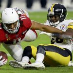 Arizona Cardinals wide receiver Larry Fitzgerald (11) is tackled by Pittsburgh Steelers cornerback Mike Hilton (28) during the first half of an NFL football game, Sunday, Dec. 8, 2019, in Glendale, Ariz. (AP Photo/Ross D. Franklin)