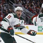Minnesota Wild left wing Zach Parise (11) celebrates a goal by right wing Mats Zuccarello, right, as Arizona Coyotes defenseman Jakob Chychrun, left, watches during the third period of an NHL hockey game Thursday, Dec. 19, 2019, in Glendale, Ariz. The Wild won 8-5. (AP Photo/Ross D. Franklin)