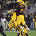 Arizona State's Chase Lucas (24) and Merlin Robertson (8) celebrate Robertson's interception against Arizona during the second half of an NCAA college football game Saturday, Nov. 30, 2019, in Tempe, Ariz. (AP Photo/Darryl Webb)