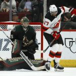 Arizona Coyotes goaltender Darcy Kuemper (35) moves into position to make a save as New Jersey Devils right wing Wayne Simmonds (17) tries to redirect the puck during the second period of an NHL hockey game, Saturday, Dec. 14, 2019, in Glendale, Ariz. (AP Photo/Ross D. Franklin)
