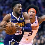 Denver Nuggets guard Malik Beasley (25) drives past Phoenix Suns forward Kelly Oubre Jr. in the first half of an NBA basketball game, Monday, Dec. 23, 2019, in Phoenix. (AP Photo/Rick Scuteri)
