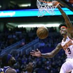 Phoenix Suns forward Kelly Oubre Jr. (3) dunks over Denver Nuggets center Nikola Jokic (15), left, and Paul Millsap (4) in the second half during an NBA basketball game, Monday, Dec. 23, 2019, in Phoenix. The Nuggets defeated the Suns 113-111. (AP Photo/Rick Scuteri)