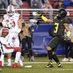 Oregon wide receiver Johnny Johnson III (3) reacts after catching a pass, next to Utah defensive backs R.J. Hubert (10) and Josh Nurse (14) during the first half of the Pac-12 Conference championship NCAA college football game in Santa Clara, Calif., Friday, Dec. 6, 2018. (AP Photo/Tony Avelar)