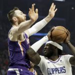 Los Angeles Clippers forward Montrezl Harrell, right, collides with Phoenix Suns center Aron Baynes during the first half of an NBA basketball game in Los Angeles, Tuesday, Dec. 17, 2019. (AP Photo/Chris Carlson)