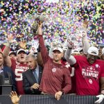 Oklahoma head coach Lincoln Riley hosts the Big 12 Conference championship trophy after defeating Baylor 30-23 in overtime in an NCAA college football game, Saturday, Dec. 7, 2019, in Arlington, Texas. (AP Photo/Jeffrey McWhorter)