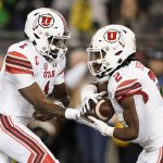 Utah quarterback Tyler Huntley (1) hands off to running back Zack Moss (2) during the first half against Oregon in the Pac-12 Conference championship NCAA college football game in Santa Clara, Calif., Friday, Dec. 6, 2018. (AP Photo/Tony Avelar)