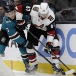 Arizona Coyotes' Lawson Crouse, right, and San Jose Sharks' Dylan Gambrell (7) fight for the puck in the second period of an NHL hockey game, Tuesday, Dec. 17, 2019, in San Jose, Calif. (AP Photo/Ben Margot)