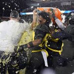 Oregon players douse coach Mario Cristobal near the end of the team's 37-15 win over Utah in an NCAA college football game for the Pac-12 Conference championship in Santa Clara, Calif., Friday, Dec. 6, 2018. (AP Photo/Tony Avelar)
