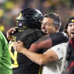 Oregon coach Mario Cristobal, right, celebrates with offensive lineman Shane Lemieux (68) after Oregon defeated Utah 37-15 in and NCAA college football game for the Pac-12 Conference championship in Santa Clara, Calif., Friday, Dec. 6, 2018. (AP Photo/Tony Avelar)