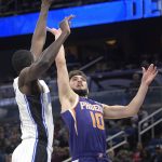 Phoenix Suns guard Ty Jerome (10) goes up for a shot in front of Orlando Magic center Mo Bamba, left, during the first half of an NBA basketball game Wednesday, Dec. 4, 2019, in Orlando, Fla. (AP Photo/Phelan M. Ebenhack)
