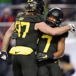 Oregon running back CJ Verdell (7) celebrates with Ryan Bay (87) after scoring a touchdown against Utah during the first half of the Pac-12 Conference championship NCAA college football game in Santa Clara, Calif., Friday, Dec. 6, 2018. (AP Photo/Tony Avelar)