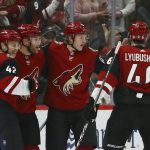 Arizona Coyotes left wing Taylor Hall, second from left, celebrates his goal against the Dallas Stars with defenseman Aaron Ness (42), center Christian Dvorak (18) and defenseman Ilya Lyubushkin (46) during the first period of an NHL hockey game Sunday, Dec. 29, 2019, in Glendale, Ariz. (AP Photo/Ross D. Franklin)
