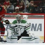 Dallas Stars goaltender Anton Khudobin, right, gives up a goal to Arizona Coyotes' Conor Garland as Coyotes center Carl Soderberg (34) looks on during the first period of an NHL hockey game, Sunday, Dec. 29, 2019, in Glendale, Ariz. (AP Photo/Ross D. Franklin)