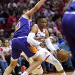 Houston Rockets' Russell Westbrook, right, drives toward the basket as Phoenix Suns' Ty Jerome (10) defends during the first half of an NBA basketball game Saturday, Dec. 7, 2019, in Houston. (AP Photo/David J. Phillip)