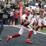 Arizona Cardinals quarterback Kyler Murray (1) scrambles out of the end zone ahead of Seattle Seahawks defensive end Ziggy Ansah (94) during the first half of an NFL football game, Sunday, Dec. 22, 2019, in Seattle. (AP Photo/Elaine Thompson)
