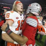 Clemson quarterback Trevor Lawrence, left, and Ohio State quarterback Justin Fields meet after the Fiesta Bowl NCAA college football playoff semifinal Saturday, Dec. 28, 2019, in Glendale, Ariz. (AP Photo/Ross D. Franklin)