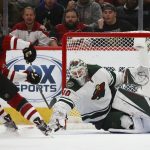 Minnesota Wild goaltender Devan Dubnyk (40) makes a save on a shot by Arizona Coyotes left wing Taylor Hall, left, during the third period of an NHL hockey game Thursday, Dec. 19, 2019, in Glendale, Ariz. The Wild won 8-5. (AP Photo/Ross D. Franklin)