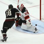 New Jersey Devils goaltender Mackenzie Blackwood (29) gets a pad on the puck on a shot from Arizona Coyotes center Christian Dvorak (18) during the third period of an NHL hockey game, Saturday, Dec. 14, 2019, in Glendale, Ariz. The Devils defeated the Coyotes 2-1. (AP Photo/Ross D. Franklin)