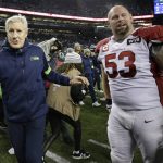 Seattle Seahawks head coach Pete Carroll, left, walks off the field next to Arizona Cardinals center A.Q. Shipley (53) very near the end of an NFL football game, Sunday, Dec. 22, 2019, in Seattle. (AP Photo/Lindsey Wasson)