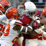 Arizona Cardinals running back Kenyan Drake, center, is tackled by Cleveland Browns free safety Damarious Randall, left, and Cleveland Browns cornerback Greedy Williams, right, during the first half of an NFL football game, Sunday, Dec. 15, 2019, in Glendale, Ariz. (AP Photo/Rick Scuteri)