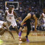 Phoenix Suns guard Devin Booker, second from right, loses the ball as Houston Rockets forward PJ Tucker, left, Rockets forward Gary Clark (6) and Rockets guard Ben McLemore (16) defend during the second half of an NBA basketball game, Saturday, Dec. 21, 2019, in Phoenix. The Rockets defeated the Suns 139-125. (AP Photo/Ross D. Franklin)