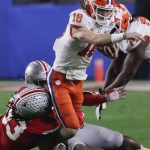 Clemson quarterback Trevor Lawrence is tackled by Ohio State defensive tackle Davon Hamilton during the first half of the Fiesta Bowl NCAA college football playoff semifinal Saturday, Dec. 28, 2019, in Glendale, Ariz. (AP Photo/Rick Scuteri)
