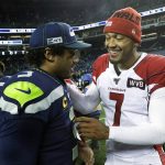 Arizona Cardinals backup quarterback Brett Hundley (7) talks with Seattle Seahawks quarterback Russell Wilson, left, following an NFL football game, Sunday, Dec. 22, 2019, in Seattle. Hundley stepped in during the second quarter after starting quarterback Kyler Murray left with an injury and the Cardinals won 27-13. (AP Photo/Elaine Thompson)