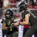 Oregon quarterback Justin Herbert (10) hands off to running back CJ Verdell (7) during the second half against Utah in an NCAA college football game for the Pac-12 Conference championship in Santa Clara, Calif., Friday, Dec. 6, 2018. Oregon won 37-15. (AP Photo/Tony Avelar)