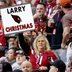 An Arizona Cardinals fan holds a sign during the first half of an NFL football game against the Cleveland Browns, Sunday, Dec. 15, 2019, in Glendale, Ariz. (AP Photo/Ross D. Franklin)