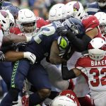 Seattle Seahawks running back Chris Carson (32) is tackled by Arizona Cardinals strong safety Budda Baker (32) and middle linebacker Jordan Hicks (58) during the first half of an NFL football game, Sunday, Dec. 22, 2019, in Seattle. (AP Photo/Lindsey Wasson)