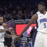 Orlando Magic center Mo Bamba (5) is congratulated by guard D.J. Augustin (14) after Bamba made a three-point shot during the first half of an NBA basketball game against the Phoenix Suns Wednesday, Dec. 4, 2019, in Orlando, Fla. (AP Photo/Phelan M. Ebenhack)