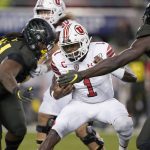 Utah quarterback Tyler Huntley (1) iis sacked by Oregon defensive tackle Jordon Scott (34) and linebacker Bryson Young (56) during the first half of the Pac-12 Conference championship NCAA college football game in Santa Clara, Calif., Friday, Dec. 6, 2018. (AP Photo/Tony Avelar)