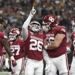 Oklahoma running back Kennedy Brooks (26) celebrates with offensive lineman Creed Humphrey (56) after rushing for a touchdown against Baylor during the first half of an NCAA college football game for the Big 12 Conference championship, Saturday, Dec. 7, 2019, in Arlington, Texas. (AP Photo/Jeffrey McWhorter)