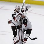 Arizona Coyotes goalie Darcy Kuemper, left, celebrates with defenseman Jakob Chychrun after the Coyotes defeated the Chicago Blackhawks 4-3 in a shootout of an NHL hockey game Sunday, Dec. 8, 2019, in Chicago. (AP Photo/Nam Y. Huh)