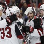 Arizona Coyotes right wing Christian Fischer, right, celebrates with teammates after scoring his goal against the Chicago Blackhawks during the first period of an NHL hockey game Sunday, Dec. 8, 2019, in Chicago. (AP Photo/Nam Y. Huh)