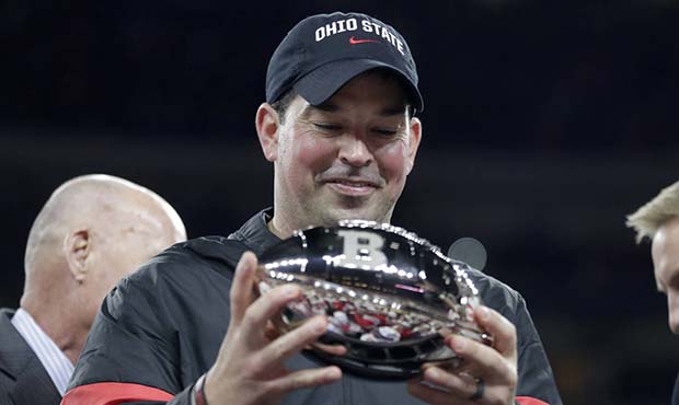 Ohio State coach Ryan Day holds the troyhy following the team's Big Ten championship NCAA college f...