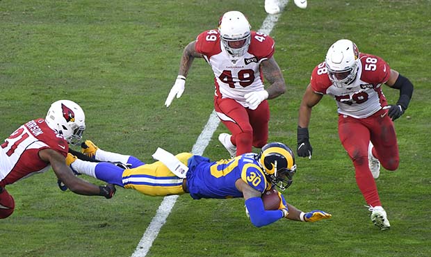 Patrick Peterson #21 brings down Todd Gurley #30 of the Los Angeles Rams while Kylie Fitts #49 and ...