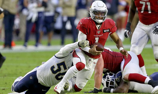Arizona Cardinals quarterback Kyler Murray (1) is tackled by Los Angeles Rams outside linebacker Sa...