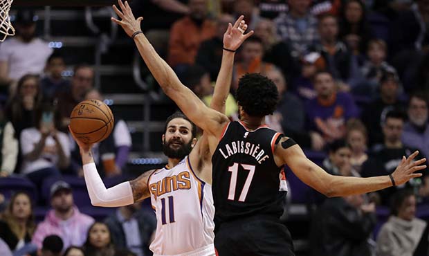 Phoenix Suns guard Ricky Rubio (11) passes around Portland Trail Blazers forward Skal Labissiere (1...