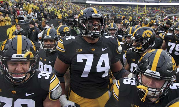 Offensive lineman Tristan Wirfs #74 of the Iowa Hawkeyes celebrates with teammates after their matc...