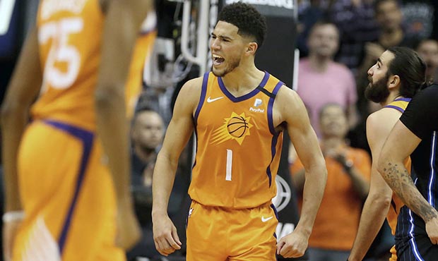 Phoenix Suns' Devin Booker (1) celebrate after back-to-back three-point baskets and a turnover agai...