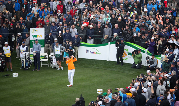 Rickie Fowler plays a tee shot on the 11th hole during the final round of the Waste Management Phoe...