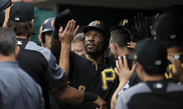 Starling Marte #6 of the Pittsburgh Pirates is congratulated by teammates after scoring in the firs...