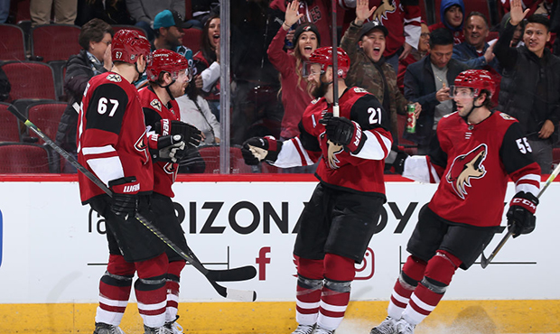 Lawson Crouse #67, Phil Kessel #81, Derek Stepan #21 and Jason Demers #55 of the Arizona Coyotes ce...