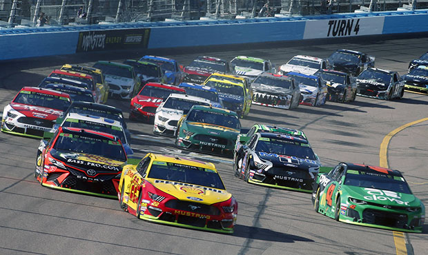 Joey Logano (22) leads the field through Turn 4 during a NASCAR Cup Series auto race at ISM Raceway...