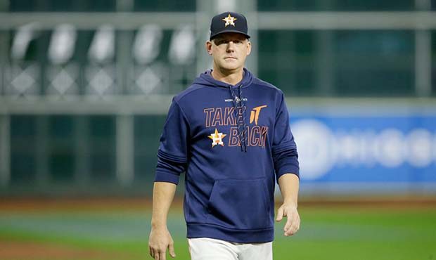 AJ Hinch #14 of the Houston Astros looks on during batting practice prior to Game Seven of the 2019...