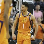 Phoenix Suns' Devin Booker (1) celebrate after back-to-back three-point baskets and a turnover against the Orlando Magic during the second half of an NBA basketball game Friday, Jan. 10, 2020, in Phoenix. (AP Photo/Darryl Webb)