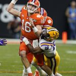 Clemson quarterback Trevor Lawrence passes under pressure from LSU linebacker K'Lavon Chaisson during the first half of a NCAA College Football Playoff national championship game Monday, Jan. 13, 2020, in New Orleans. (AP Photo/David J. Phillip)